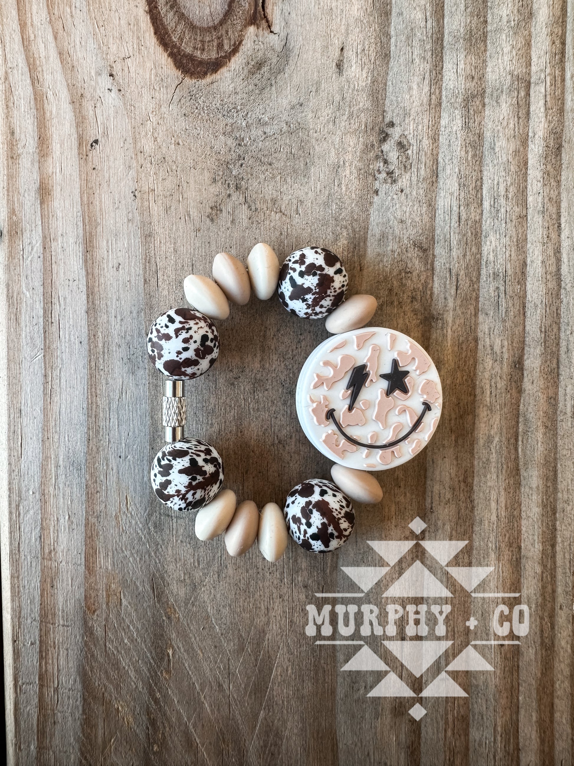NEUTRAL COW PRINT SMILEY CUP CHARM