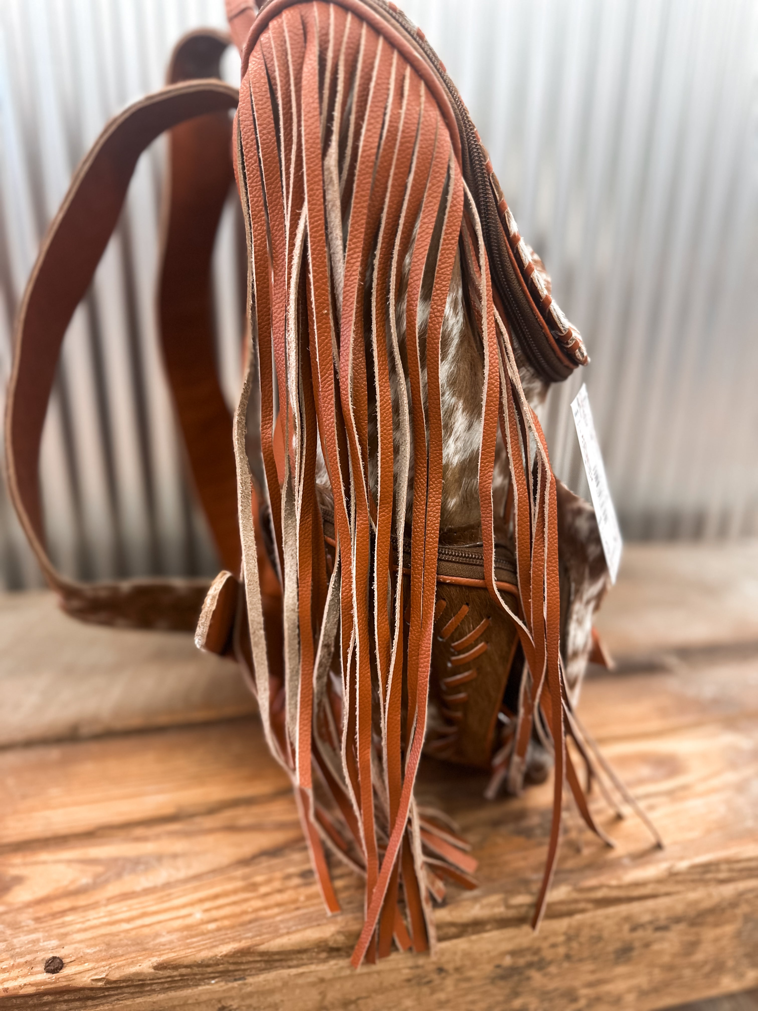 COWHIDE FRINGE BACKPACK - BROWN