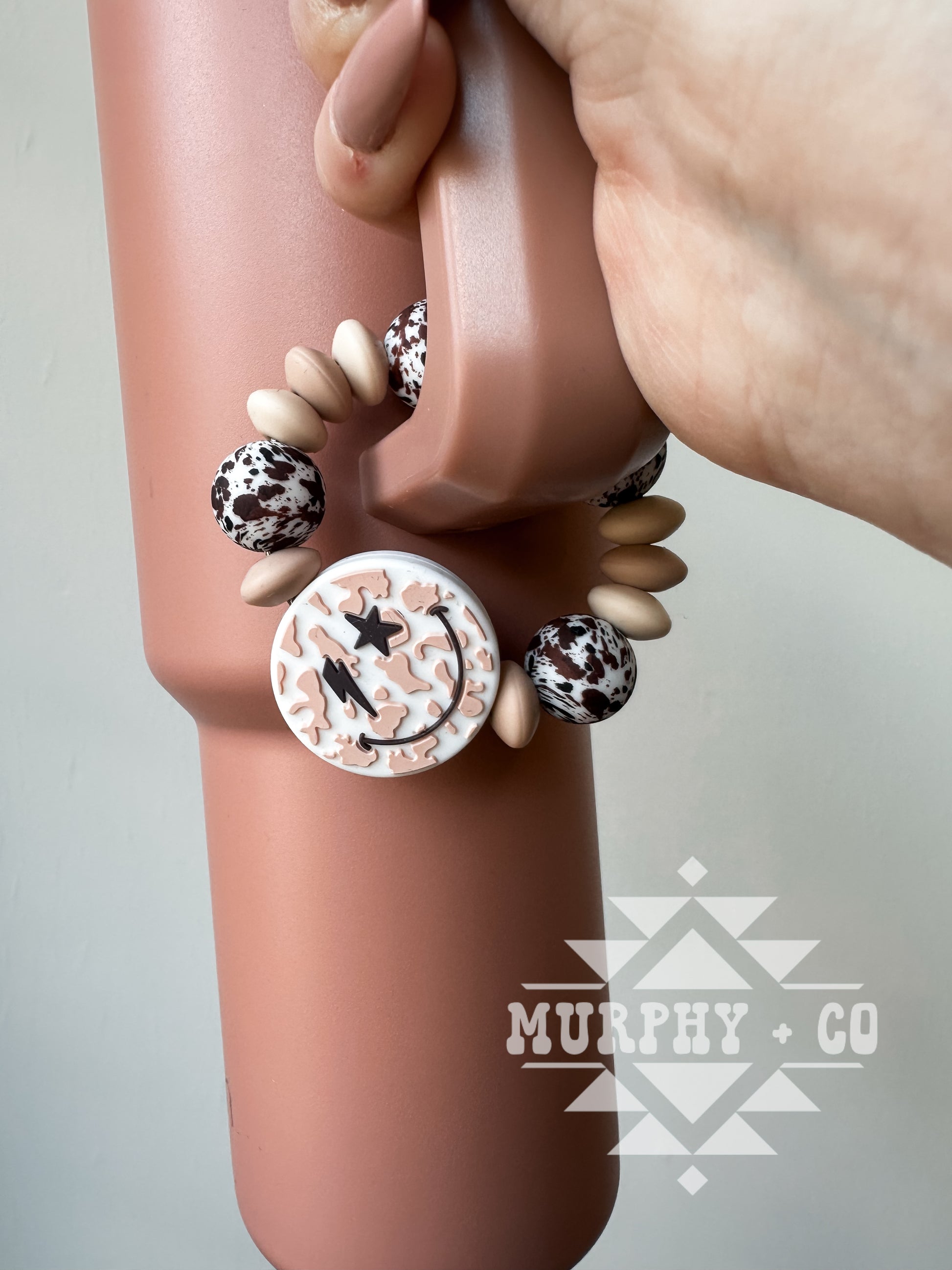 NEUTRAL COW PRINT SMILEY CUP CHARM
